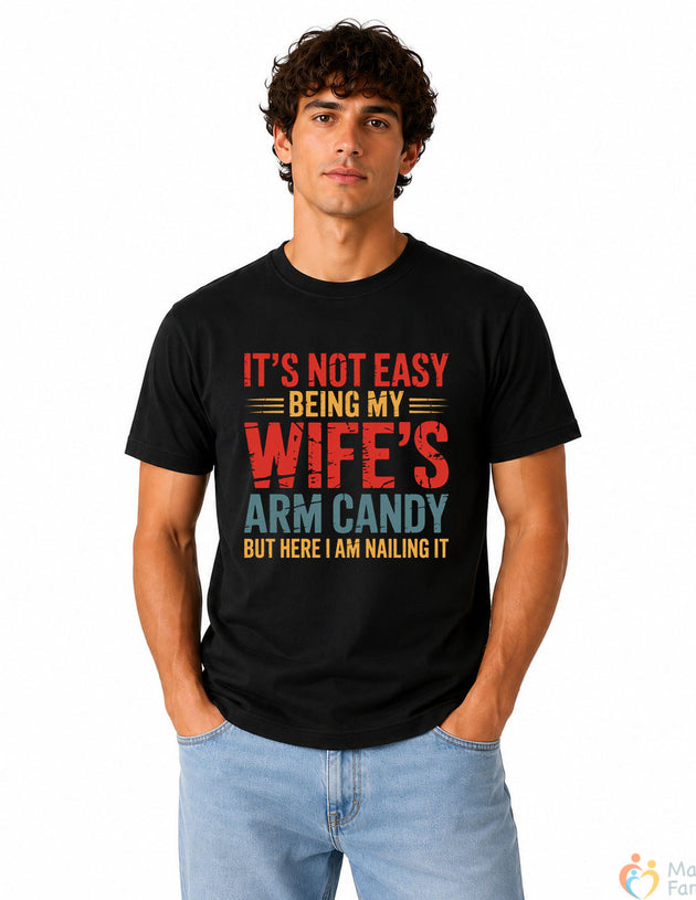 It's Not Easy Being My Wife's Arm Candy Funny Men's T-Shirt | Humorous Husband Graphic Cotton Tee | Gift for Husbands